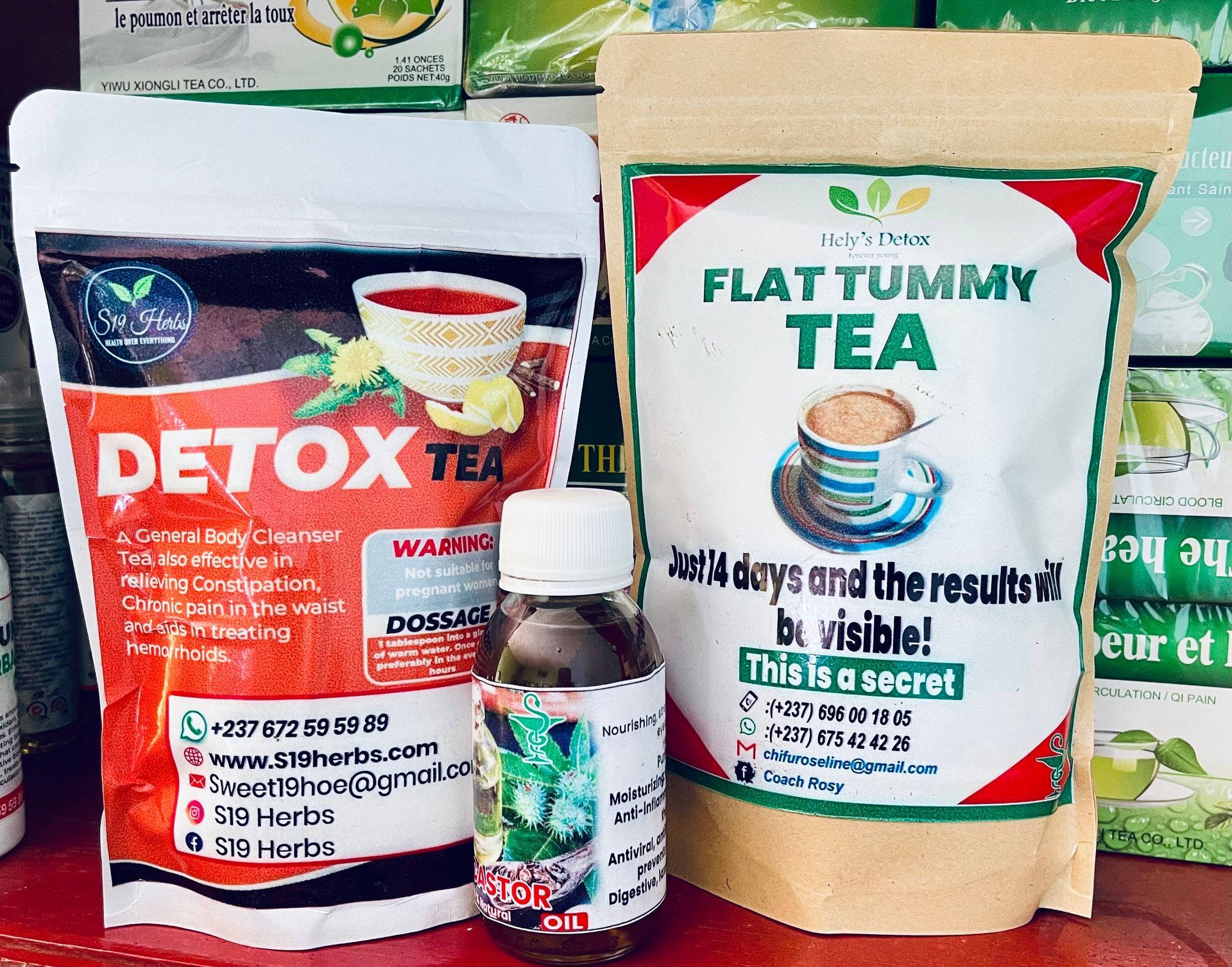 Packets of detox and flat tummy tea with a bottle of castor oil on a shelf.