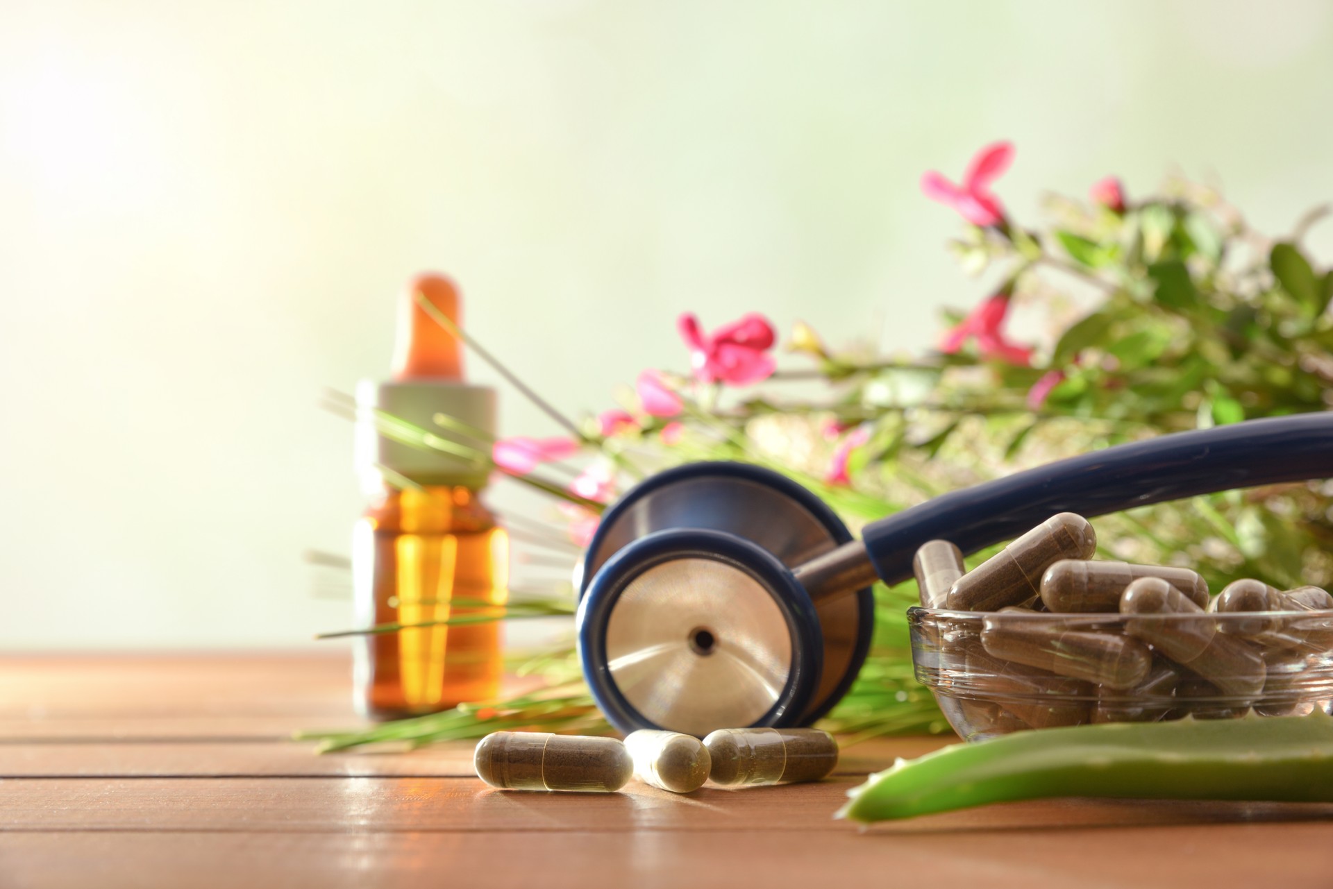 Natural herbal medicine capsules on table pants and jar front